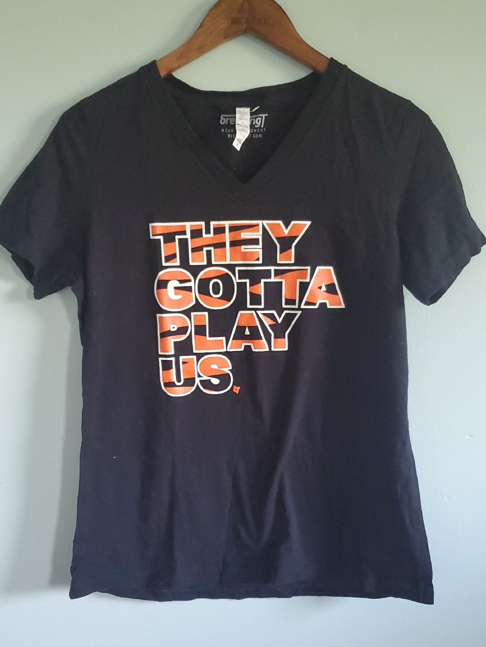 Black V-Neck Tee with Orange Graphic - "They Gotta Play Us"